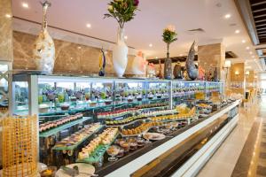 a display case in a store filled with food at Karmir Resort & Spa - Ultra All Inclusive in Kemer