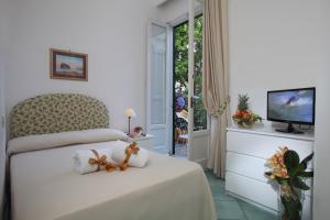 a bedroom with a bed with two teddy bears on it at Hotel & Residence Matarese in Ischia