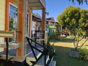 ein Haus mit einer Holztreppe, die zur Eingangstür führt in der Unterkunft มุกดาสวรรค์ รีสอร์ท - Mukda Sawan Resort in Mukdahan