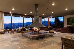 a living room with a fireplace in the middle at Amalia Hotel Delphi in Delfoi