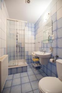 a blue and white bathroom with a toilet and a sink at Gospoda Graniczna Bombaj Jakuszyce in Szklarska Poręba +70 photos