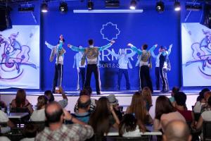 a group of people standing on a stage with their arms out at Karmir Resort & Spa - Ultra All Inclusive in Kemer