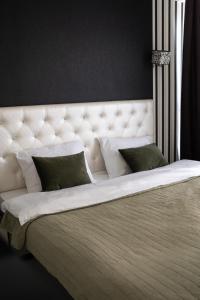a large white bed with two pillows on it at RentWill apartments Black&White in Chişinău