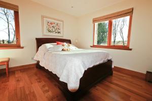 a bedroom with a bed with two teddy bears on it at Anglers Retreat in Brechin