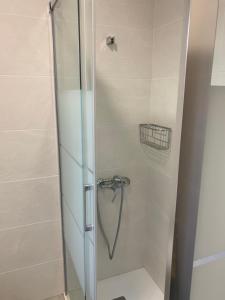 a shower with a glass door in a bathroom at La casa de papel in Almería