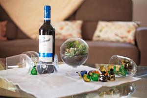 a bottle of wine sitting on a table with a glass ball at Casa Chiripa in Tarajalejo