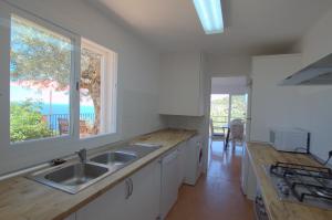 a kitchen with a sink and a window at Alconasser 2 - Amazing Seaviews between Deia & Soller in Sóller