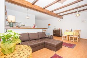 a living room with a brown couch and a table at Studio apartment in Orebic with sea view, terrace, air conditioning, WiFi 114-3 in Orebić