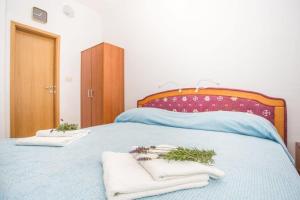 a bedroom with a blue bed with towels on it at Studio apartment in Orebic with sea view, terrace, air conditioning, WiFi 114-3 in Orebić +39 photos