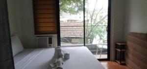 Postel nebo postele na pokoji v ubytování ONE OASIS a1 SM MALL DAVAO FREE POOL WIFI