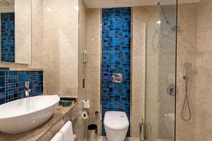 a bathroom with a sink and a toilet and a shower at Karmir Resort & Spa - Ultra All Inclusive in Kemer