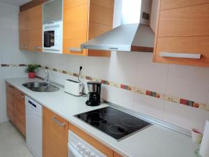 a small kitchen with a sink and a stove at Piso Mirador Ses Cales 61 en Calas de Mallorca in Calas de Mallorca