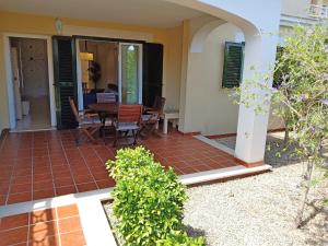 a house with a patio with a table and chairs at Piso Mirador Ses Cales 61 en Calas de Mallorca in Calas de Mallorca