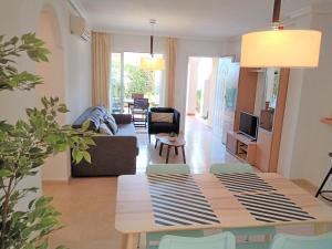 a living room with a table and a couch at Piso Mirador Ses Cales 61 Calas de Mallorca in Calas de Mallorca