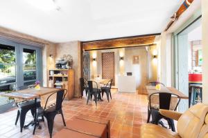 a dining room with tables and chairs and a kitchen at Hotel Pop Alaçatı in Alaçatı