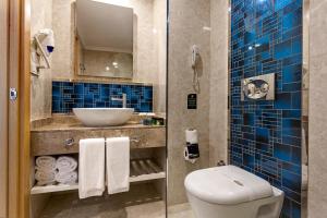 a bathroom with a toilet and a sink at Karmir Resort & Spa - Ultra All Inclusive in Kemer