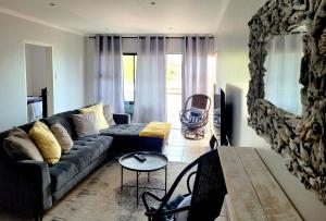 a living room with a couch and a table at Jordan's Break in Jeffreys Bay