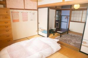 a bedroom with a large white bed in a room at Minpaku AMBO - Friendly share house - in Kazuno