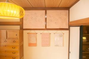 a kitchen with a refrigerator with notices on the wall at Minpaku AMBO - Friendly share house - in Kazuno