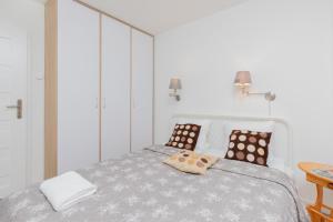a bedroom with a bed with two pillows on it at City Center Apartment Gdynia by Renters in Gdynia