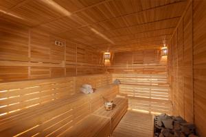 an empty sauna with wooden walls and wooden floors at Karmir Resort & Spa - Ultra All Inclusive in Kemer