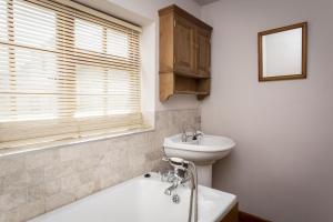 a bathroom with a sink and a tub and a toilet at Bay Cottage in Broadstairs - Winter special offers! in Broadstairs +11 photos