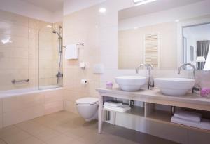 łazienka z 2 umywalkami, wanną i toaletą w obiekcie Apartments Belvedere - Liburnia w mieście Lovran