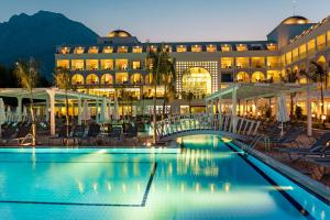 a hotel with a swimming pool in front of a building at Karmir Resort & Spa - Ultra All Inclusive in Kemer