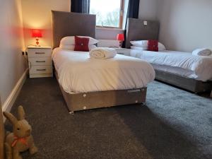 a room with two beds and a stuffed animal in it at The Rampling's in Crawley