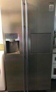 a stainless steel refrigerator in a kitchen at Logements Un Coin de Bigorre - La Tournayaise - Canal plus, Netflix, Rmc Sport - Wifi Fibre in Tournay