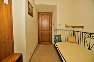 a small bedroom with a bed and a wooden door at U Schnellu in Prague