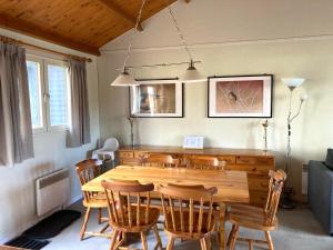 a dining room with a wooden table and chairs at Familie Meys Chalets - Chalet 249 - La Boverie in Rendeux