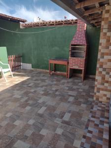 a patio with a brick oven and a table at Casa em Prado com piscina - Temporada in Prado