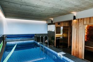 a large swimming pool in a room with a kitchen at Gorczańskie Zacisze in Lubomierz