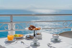 a table with a plate of pastries on a balcony at Hotel Cetus in Cetara