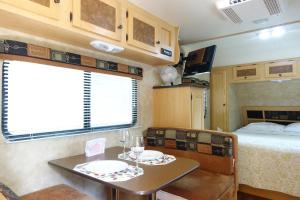 a kitchen and dining room with a table and a bed at Best RV-Studio to Visit NYC-EWR Airport-Free Parking in Hillside