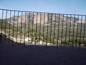 a view of a mountain through a fence at Hotel Boutique Real Posada De Liena y Restaurante Liena in Murillo de Gállego