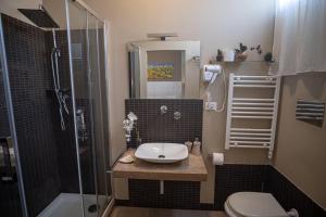 a bathroom with a toilet and a sink and a shower at B&B Le Muse in Mondello
