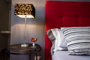a lamp on a table next to a bed at B&B Le Muse in Mondello