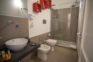 a bathroom with a sink and a toilet and a shower at B&B Le Muse in Mondello