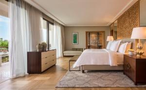 a bedroom with a bed and a large window at Four Seasons Hotel Tunis in Gammarth