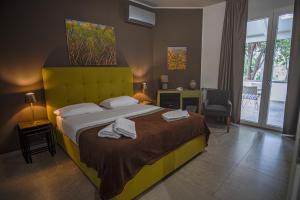 a bedroom with a large bed with towels on it at B&B Le Muse in Mondello