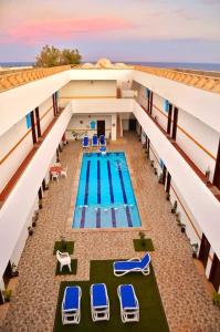 an overhead view of a swimming pool with lounge chairs at Golden Plaza Dahab Resort in Dahab