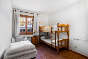 a bedroom with two bunk beds and a window at Francoli in Canillo