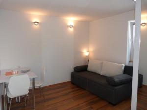 a living room with a couch and a table at Apartments Luxe Self Check in in Zagreb