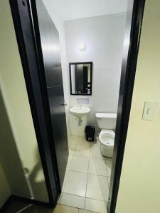 a bathroom with a toilet and a sink at Gavan Plaza Hotel in Villavicencio