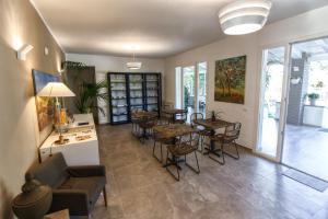 a living room with tables and chairs and a dining room at B&B Le Muse in Mondello +37 photos