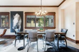 a dining room with a table and chairs and a horse painting at Arrowleaf Lodge - 2 Bed Condo #109 in Park City