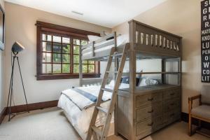 a bedroom with a bunk bed with a ladder and a dresser at Arrowleaf Lodge - 2 Bed Condo #109 in Park City