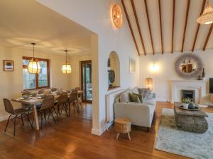 a living room with a table and a dining room at Shangri-La in Bideford